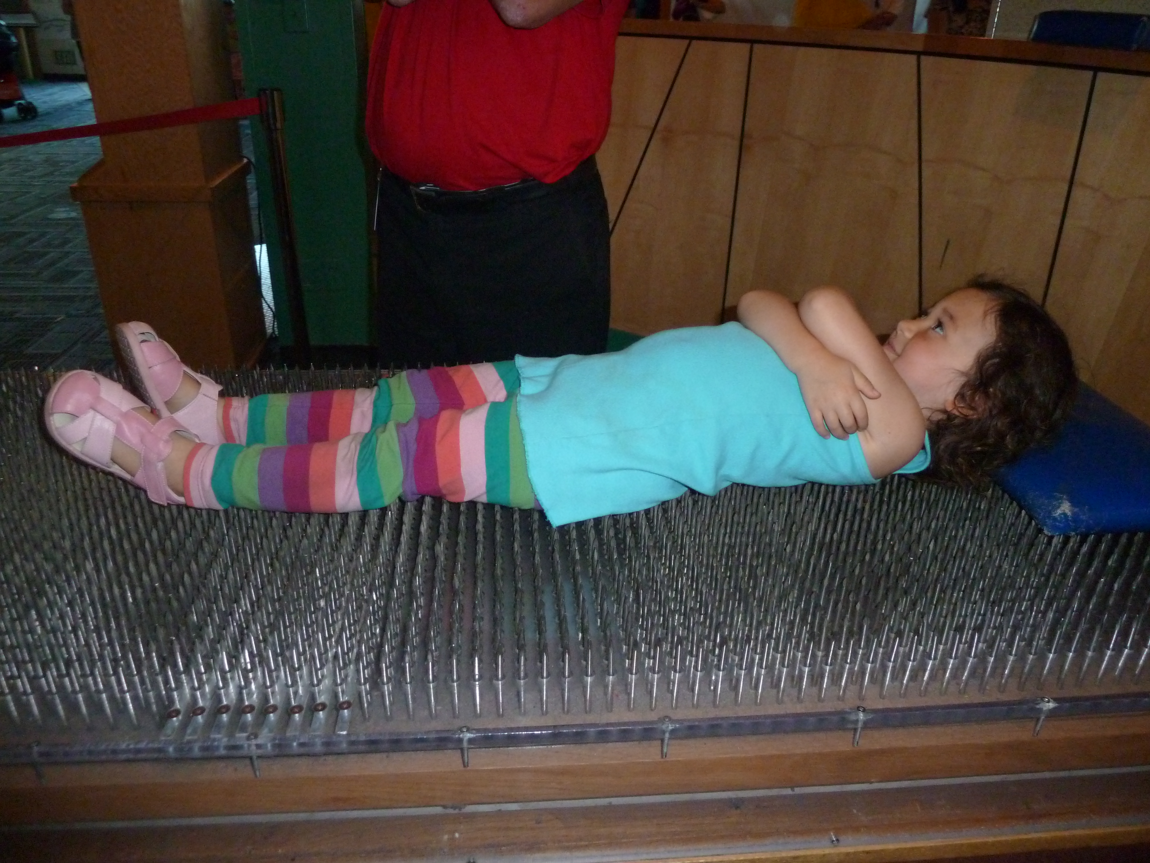 Mishy lying on a bed of nails.